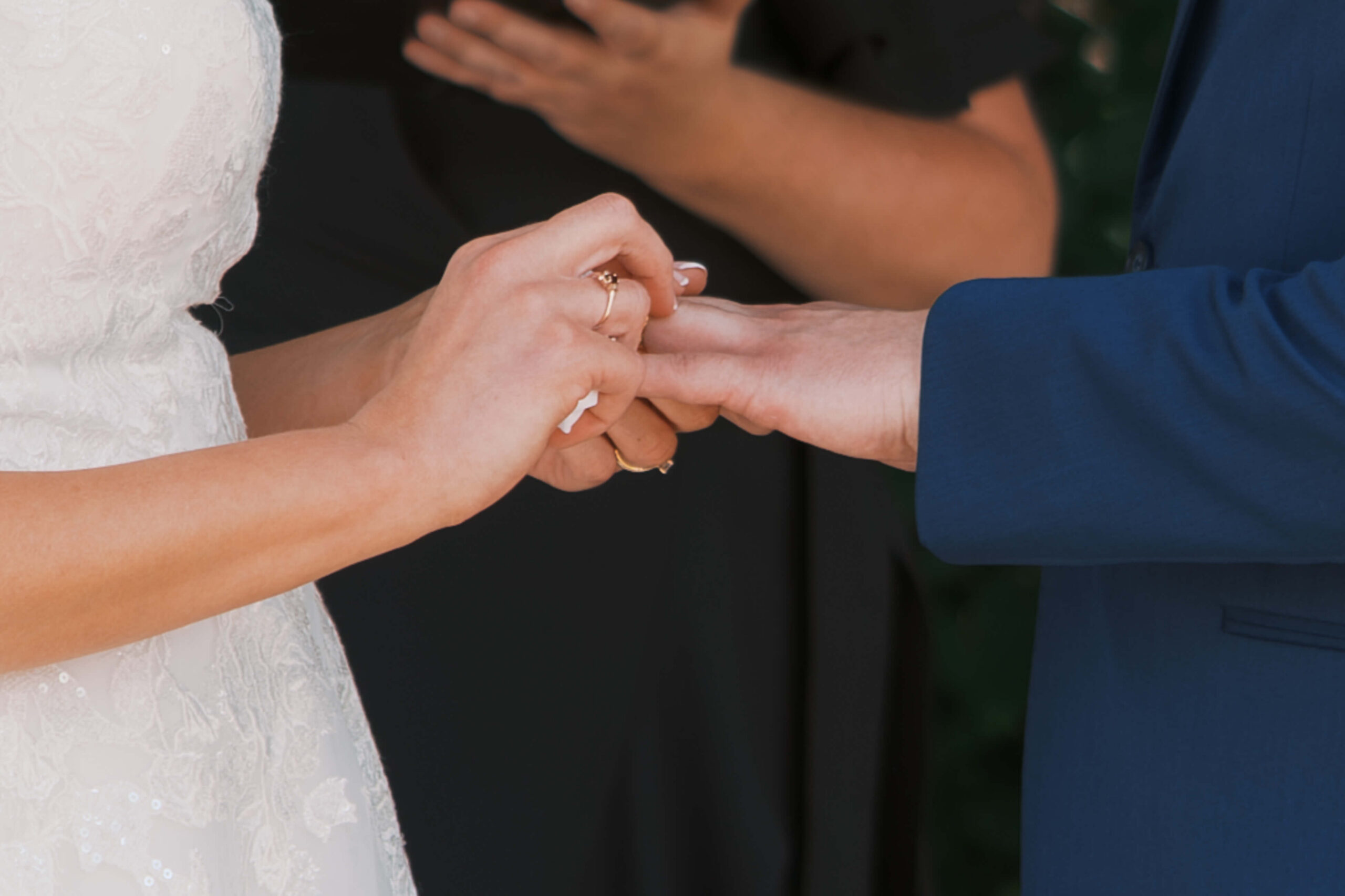 Details of newlyweds exchanging their rings during their ceremony at their Hillcrest Country Club wedding