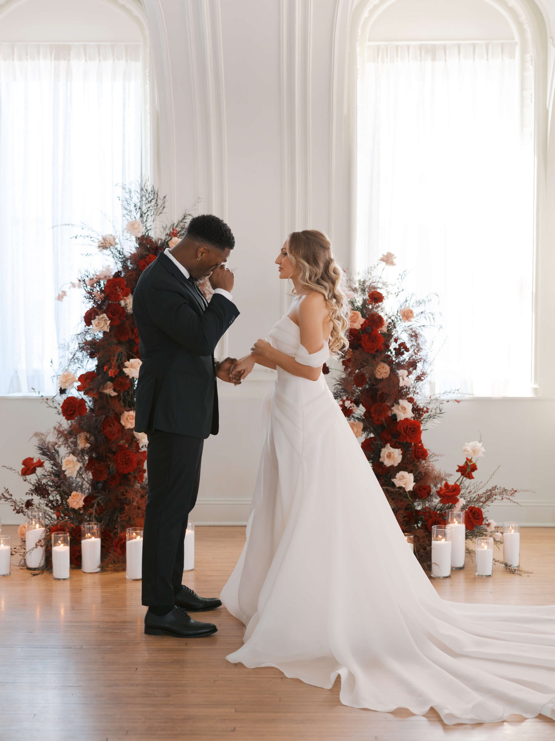 A groom wipes away tears during his cottonwood hotel wedding ceremony