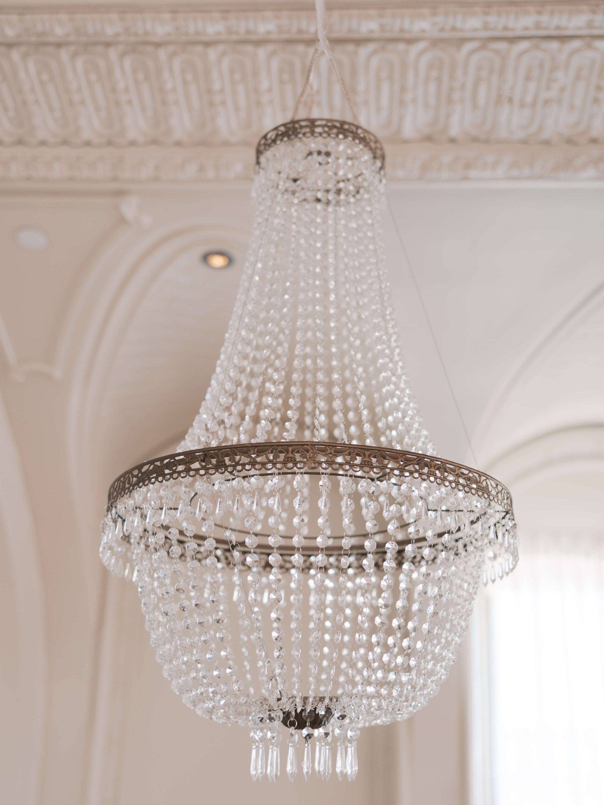 Details of a crystal chandelier hanging at the cottonwood hotel wedding venue