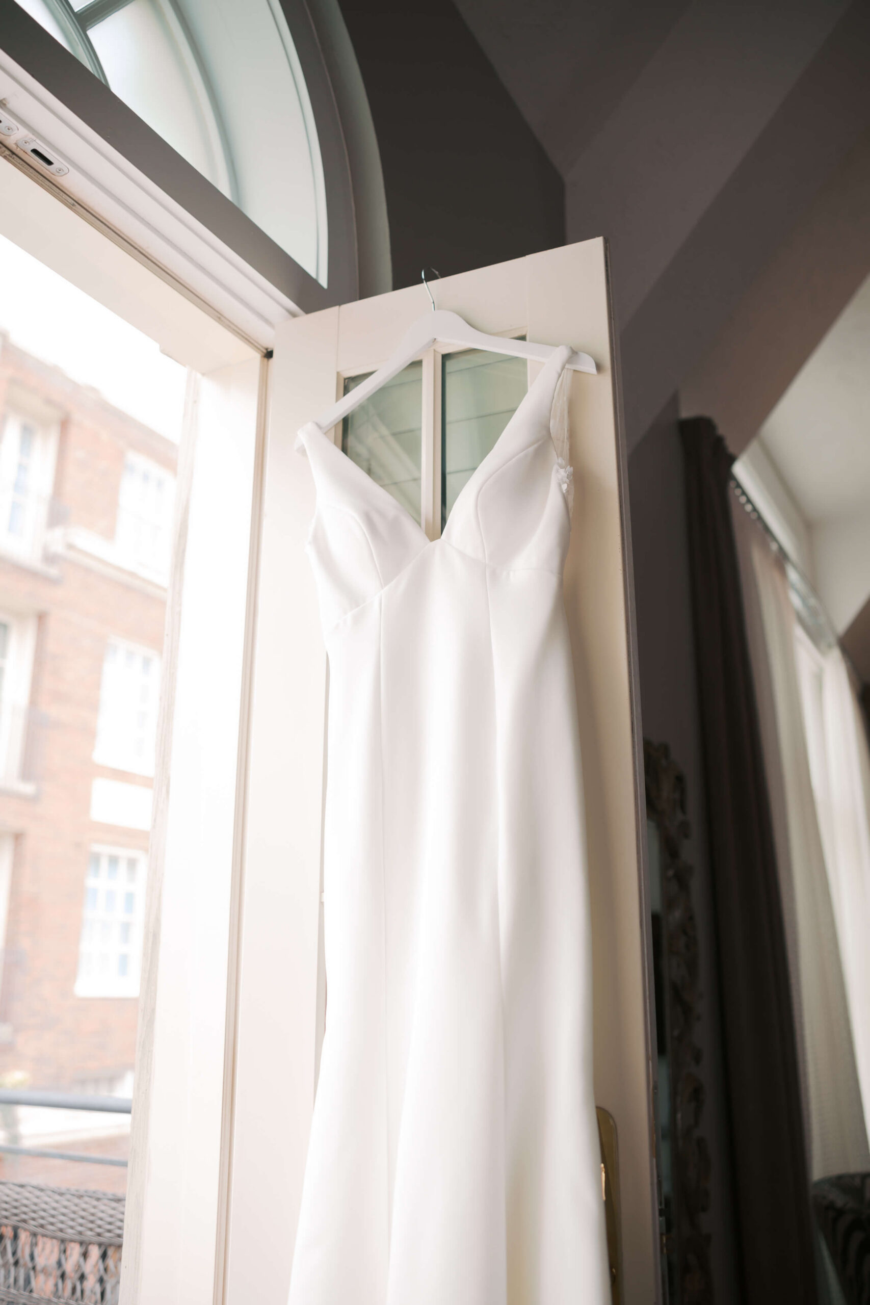 Details of a silk gown hanging in an open patio door