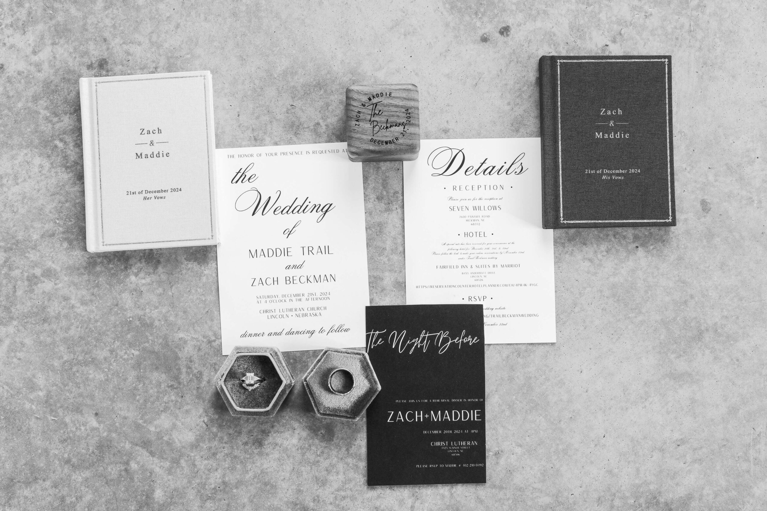 A black and white details image with invitations and wooden ring box and vows books