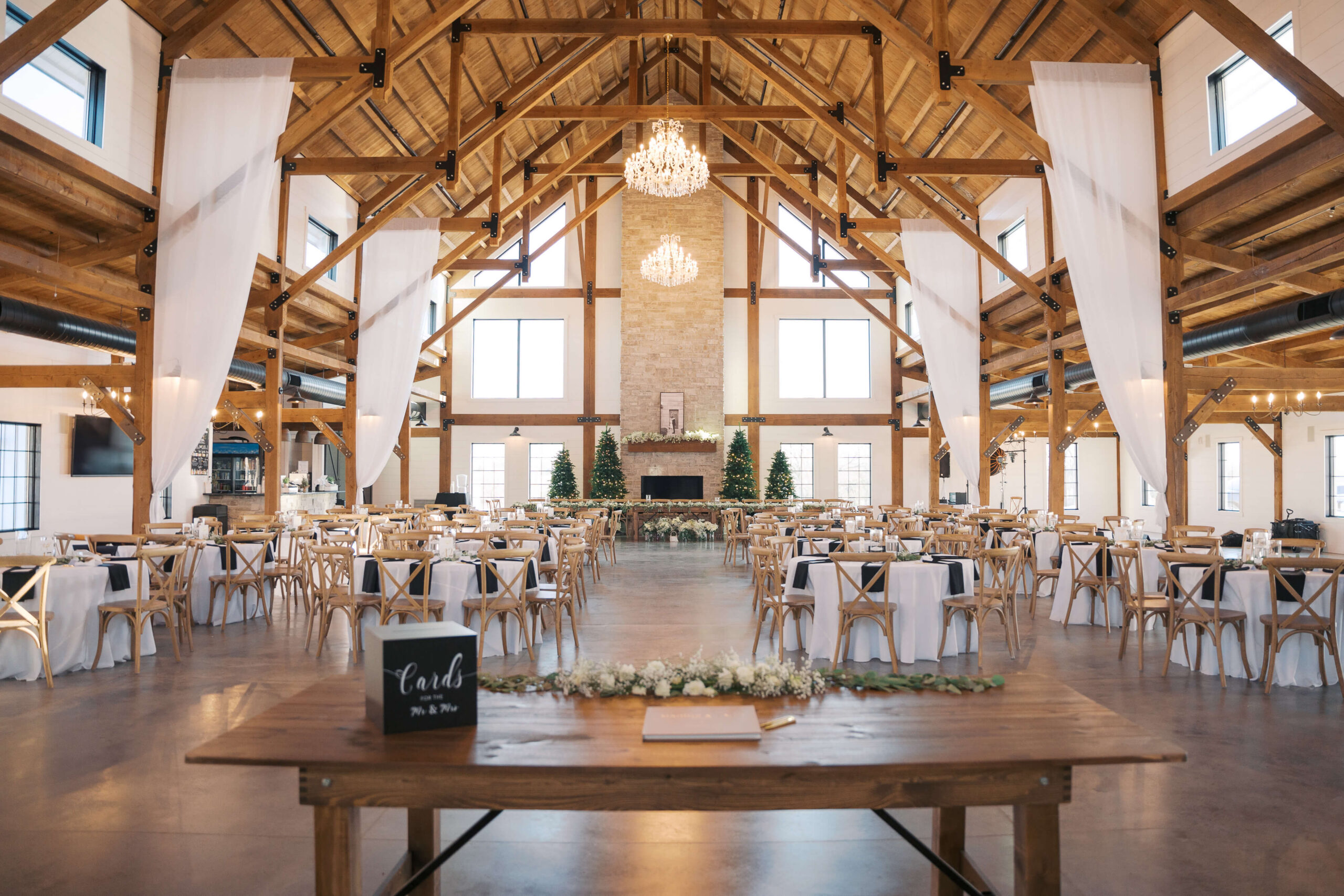 The view from the newlywed table at Seven Willows wedding venue during a set up reception with white linen and wood chairs