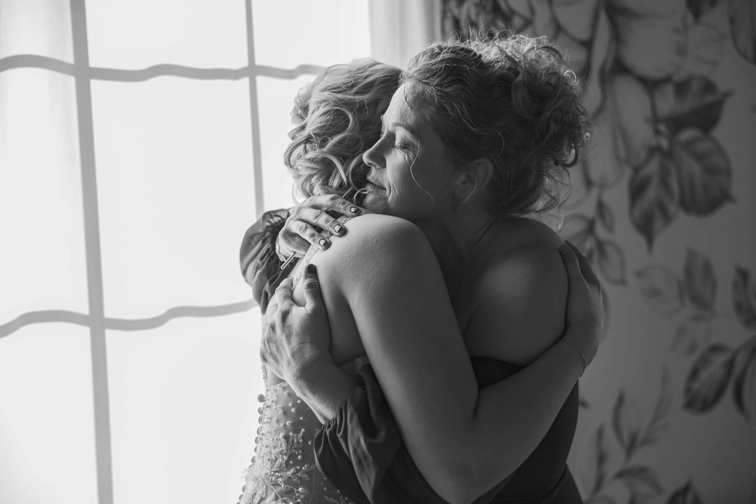 A mother hugs her daughter in the getting ready room