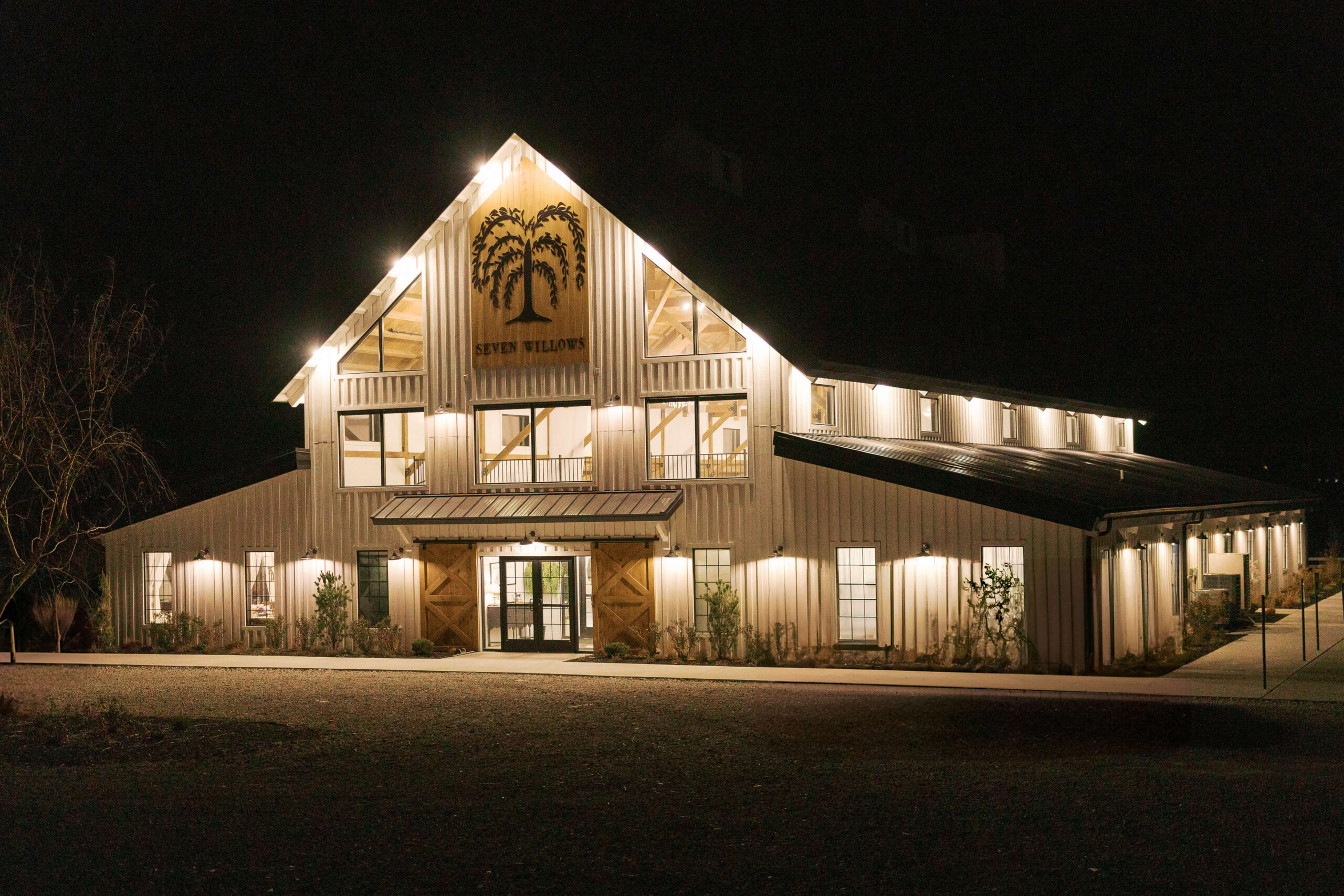 Details of the front facade of the Seven Willows wedding venue at night with a ll the lights on
