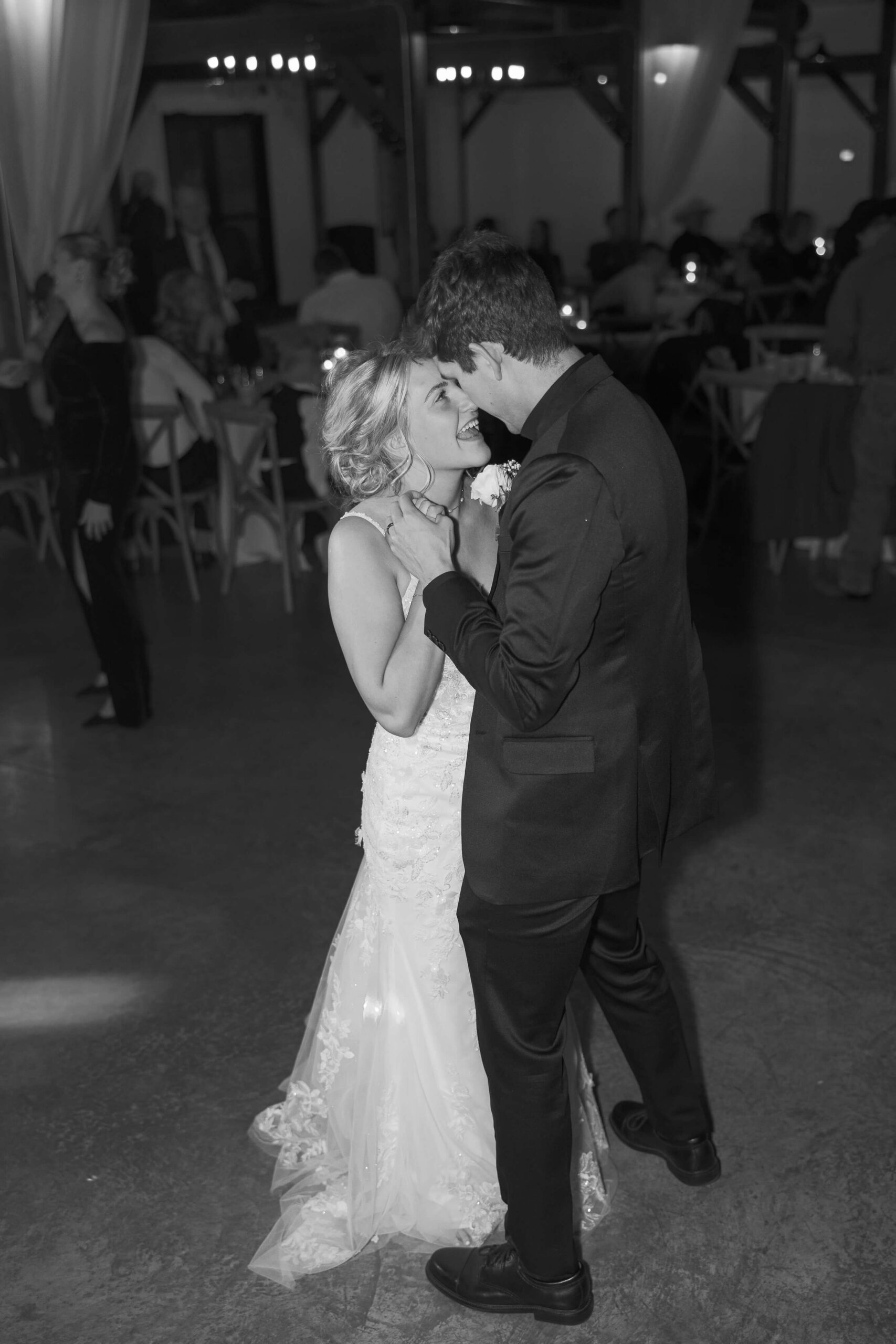 A happy bride dances touching foreheads with her groom at the Seven Willows wedding venue