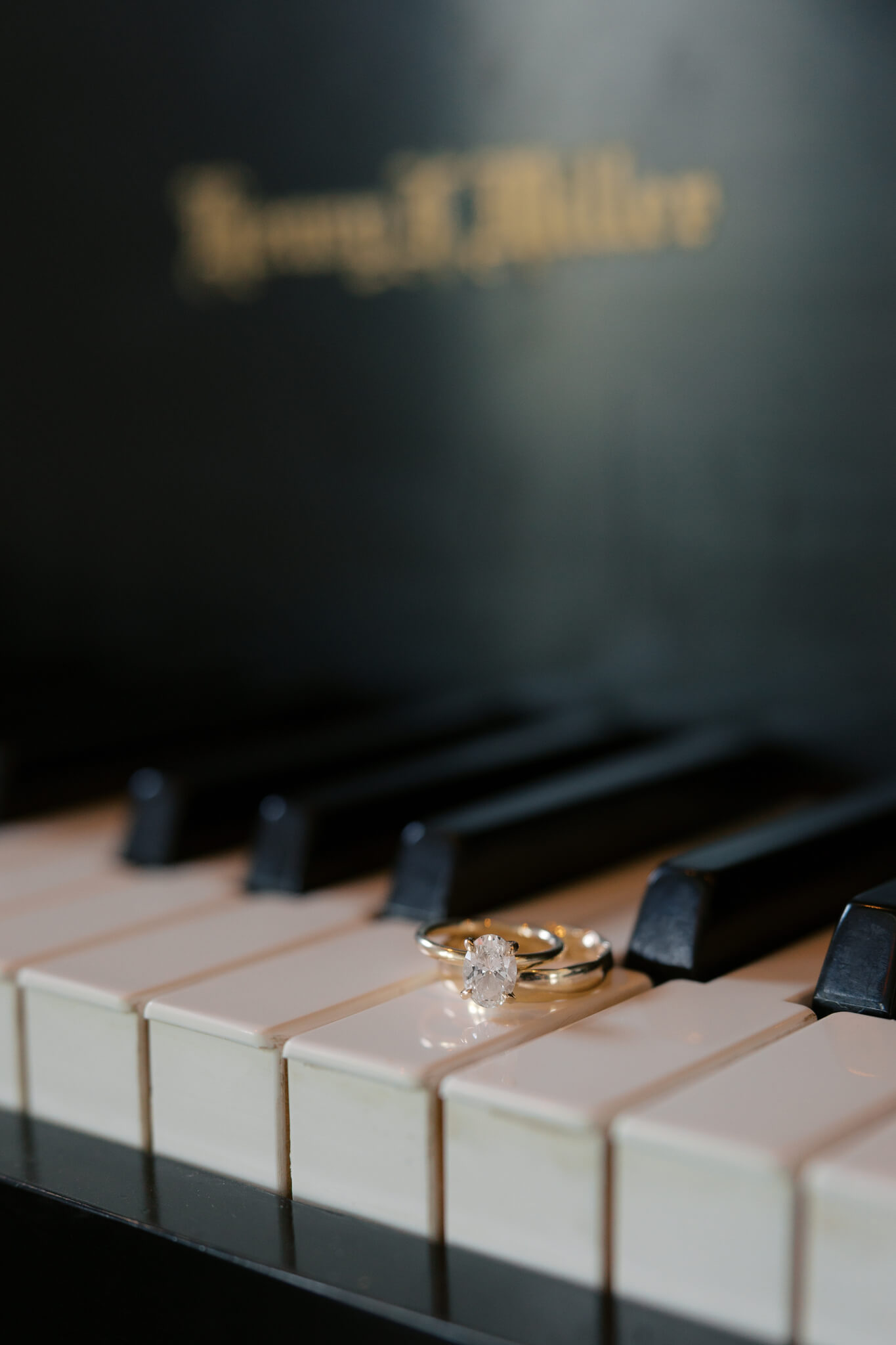 Details of a bride's rings on the keys on a piano