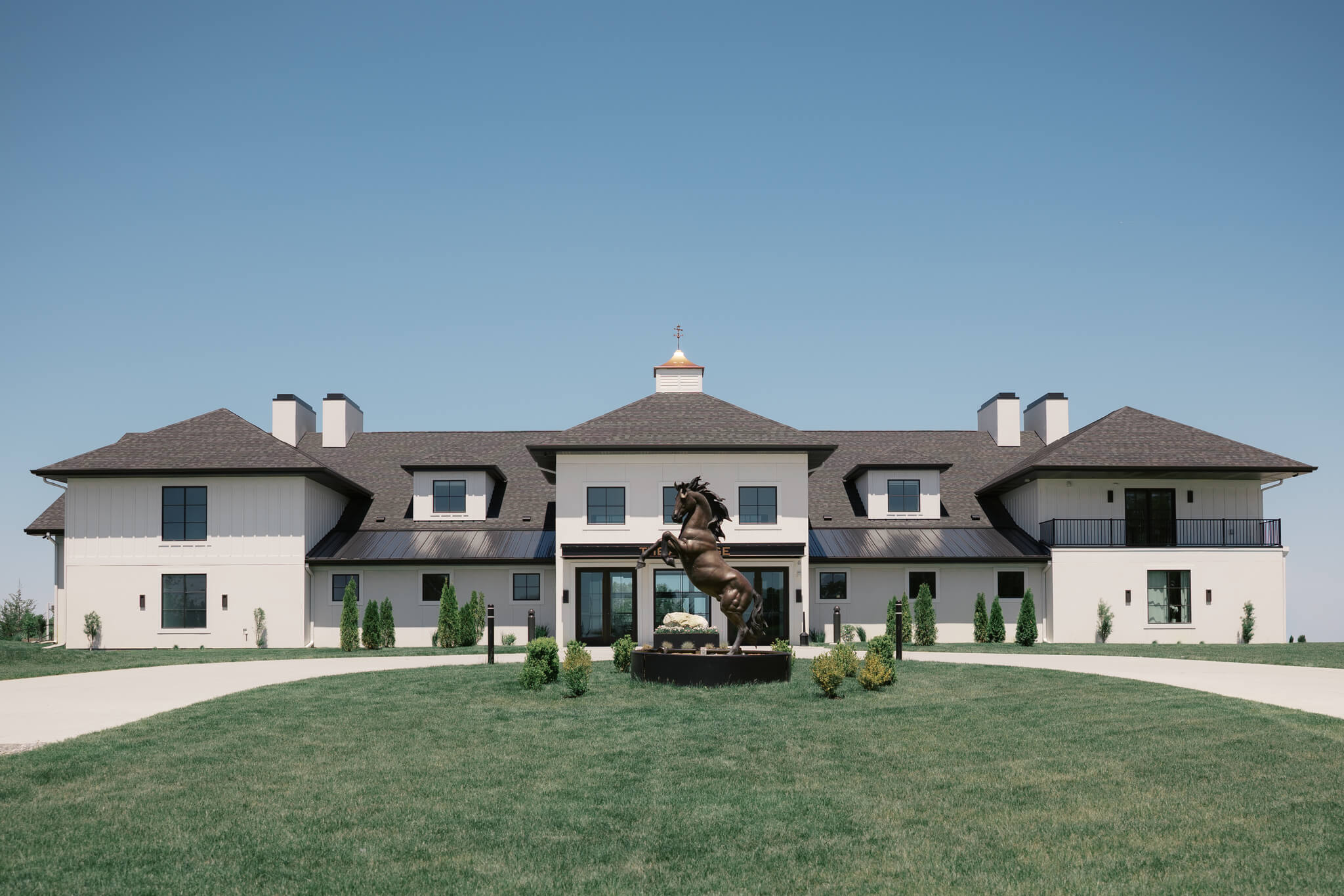 A look at the front driveway and horse statue of The Acreage wedding venue