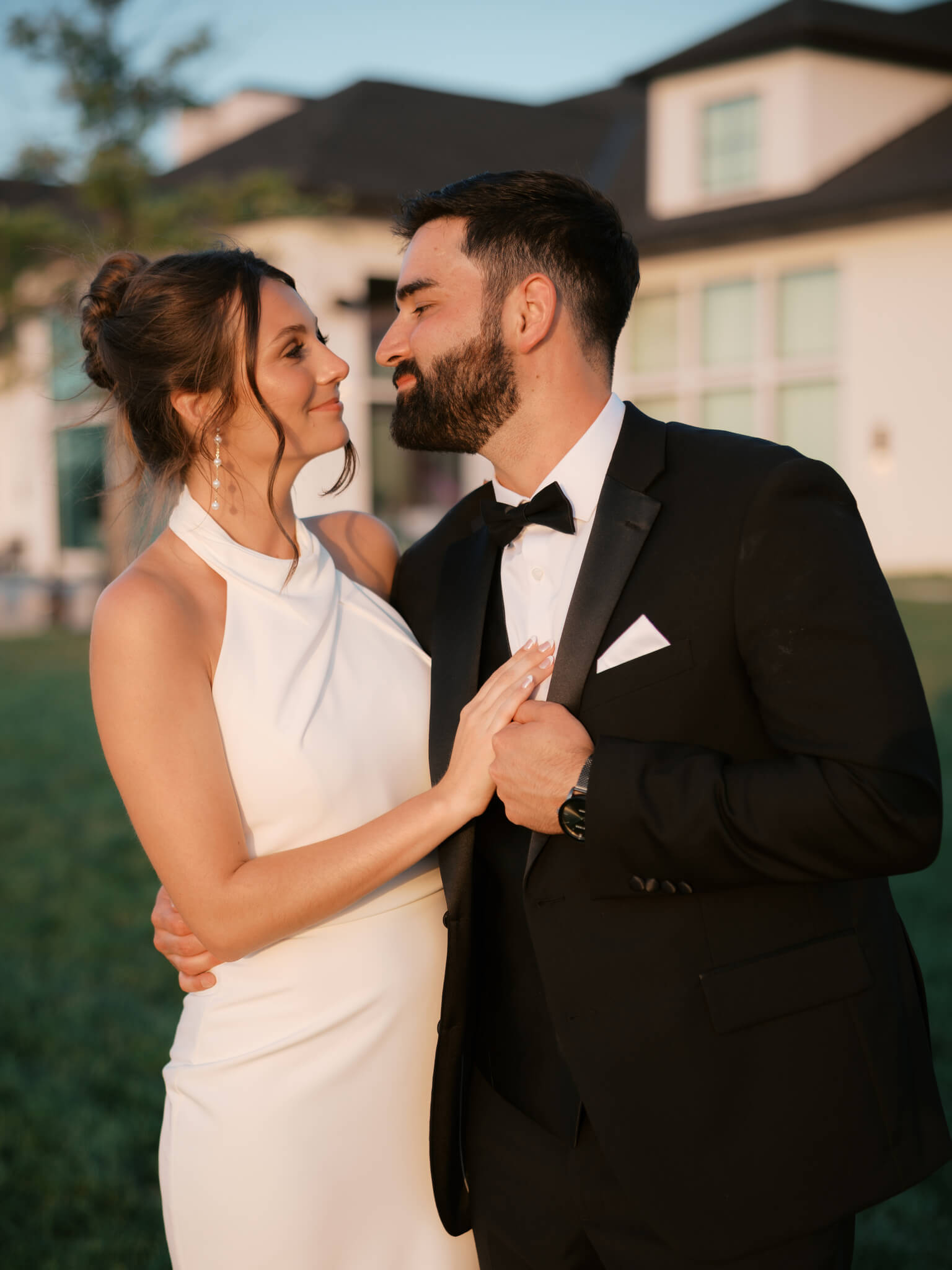 Happy newlyweds dance in the sunset and lean in for a kiss