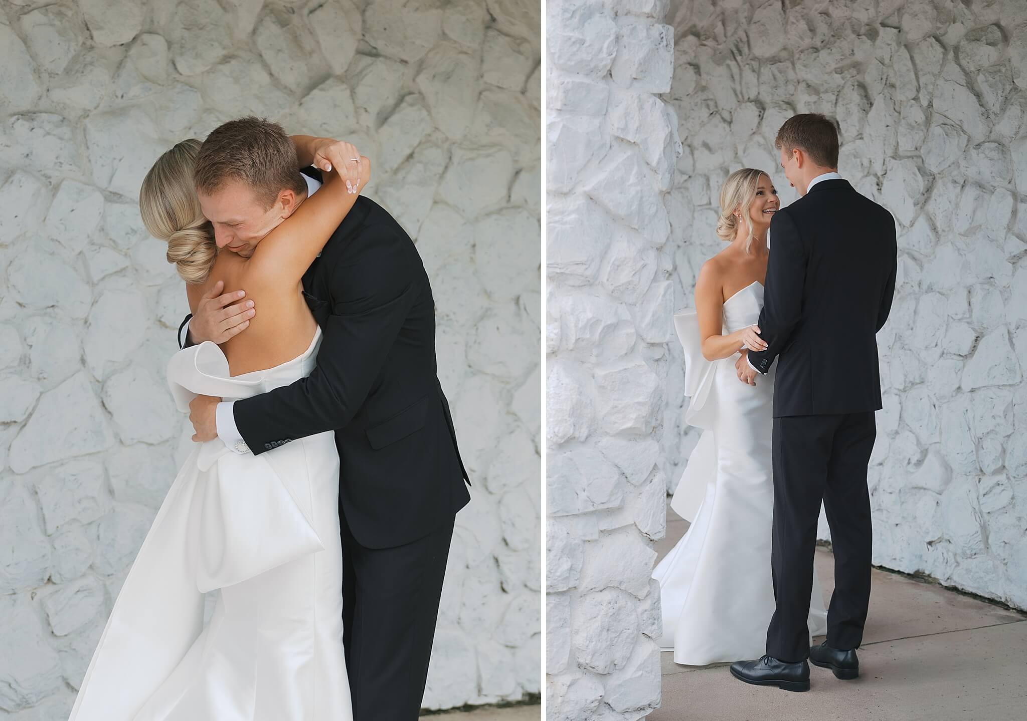 A happy couple share big smiles and a hug during their first look in a white stone wall hallway of The Fountains Ballroom wedding venue